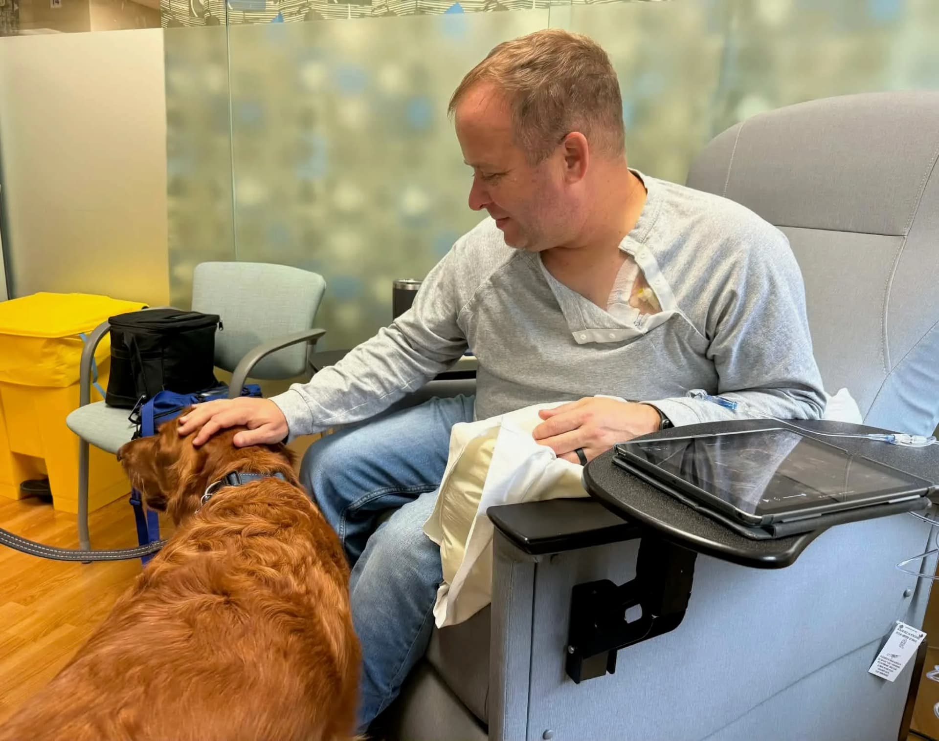 Chad Brower with a therapy dog during treatment