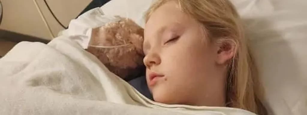 A young girl resting in a hospital bed